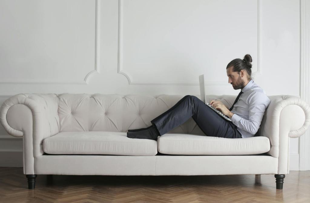 photo of man sitting on couch
